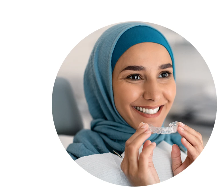 Smiling Woman In Hijab Holding Invisalign
