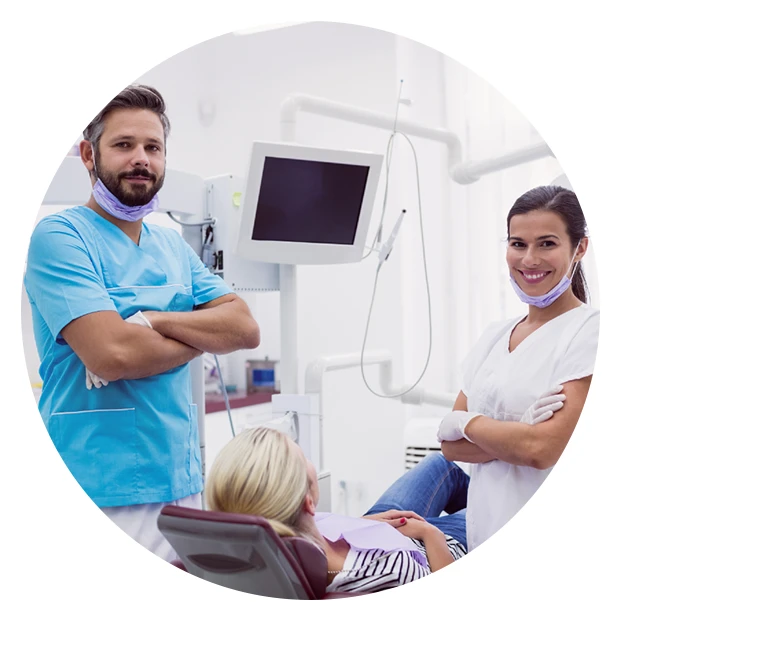 portrait of male and female dentist standing in dental clinic