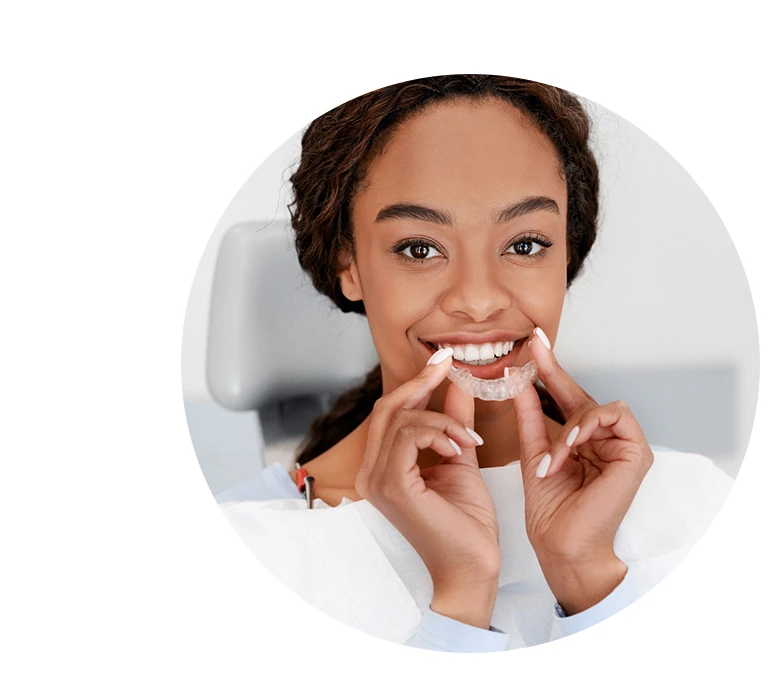 Close up of young black woman holding invisible aligner