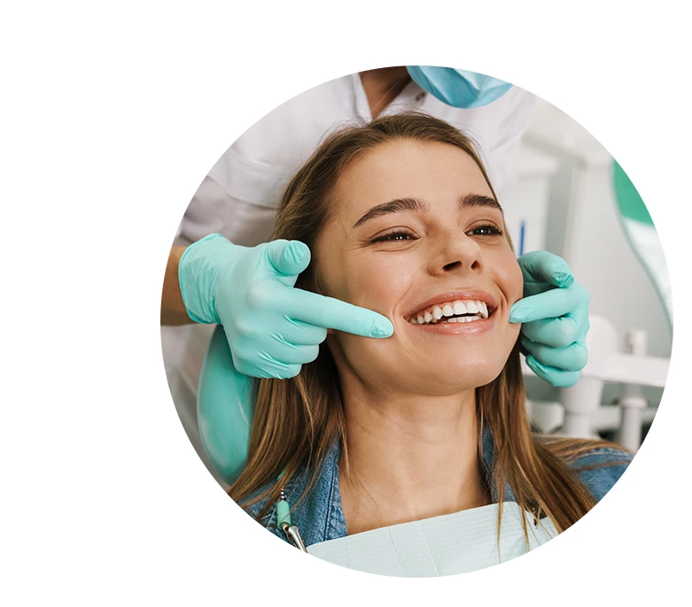 Teen girl smiling while looking at mirror in dental clinic